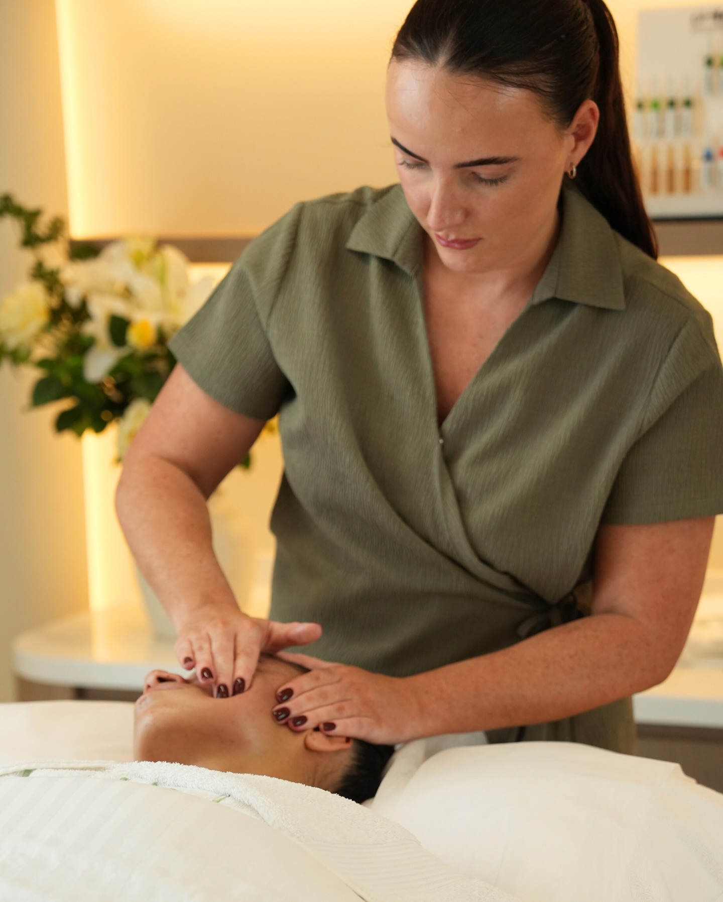 A SKIN specialist performing a facial treatment in the clinic